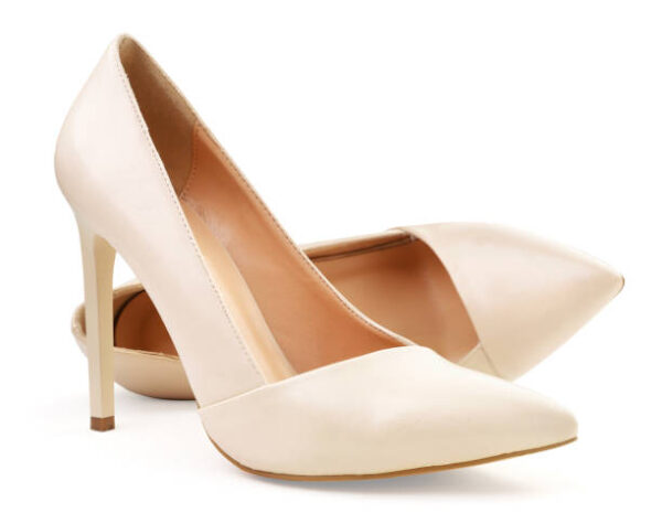 Pair of women's beige shoes close up on a white background. isolated